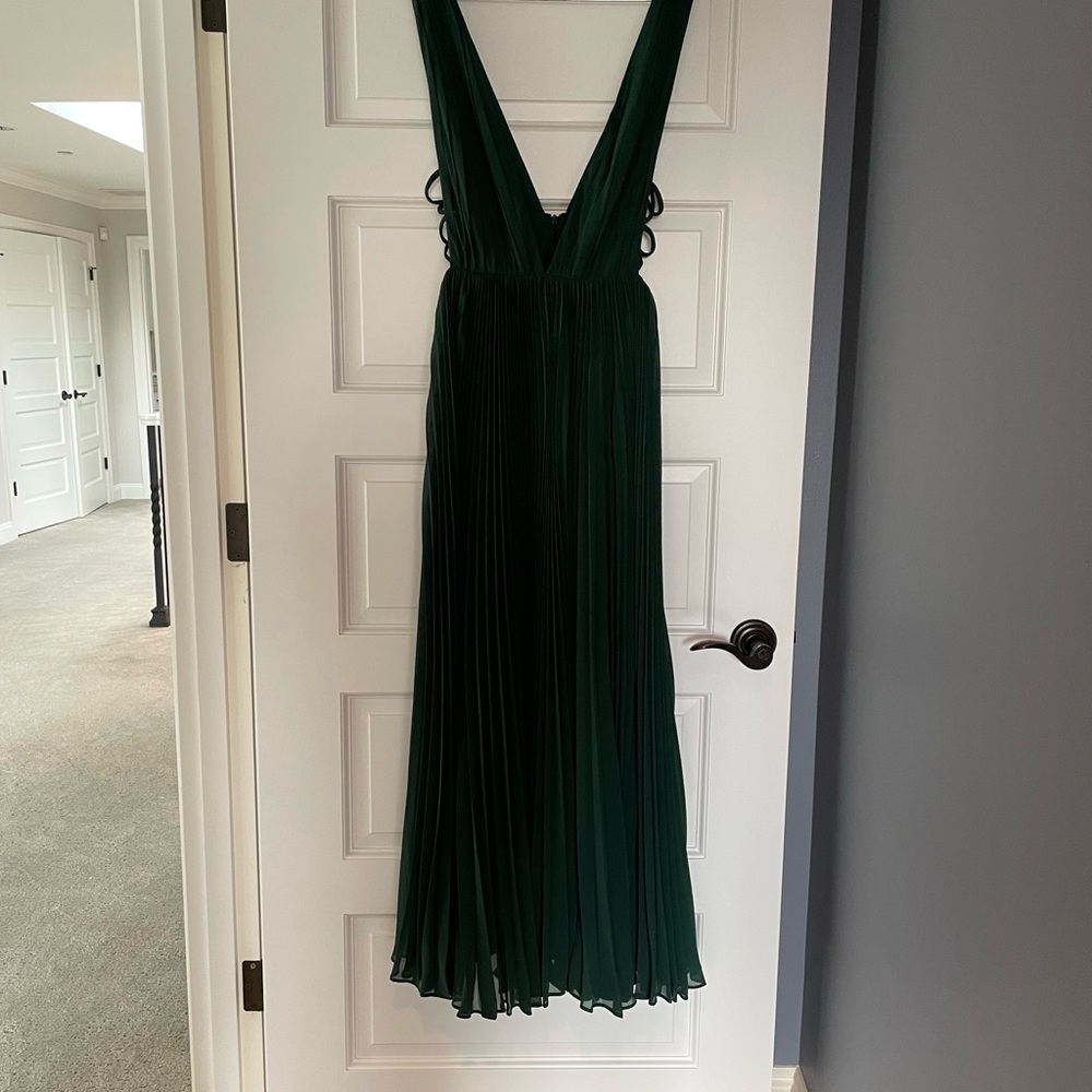 Fame and Partners The Allegra prom dress is a maxi dress featuring a pleats